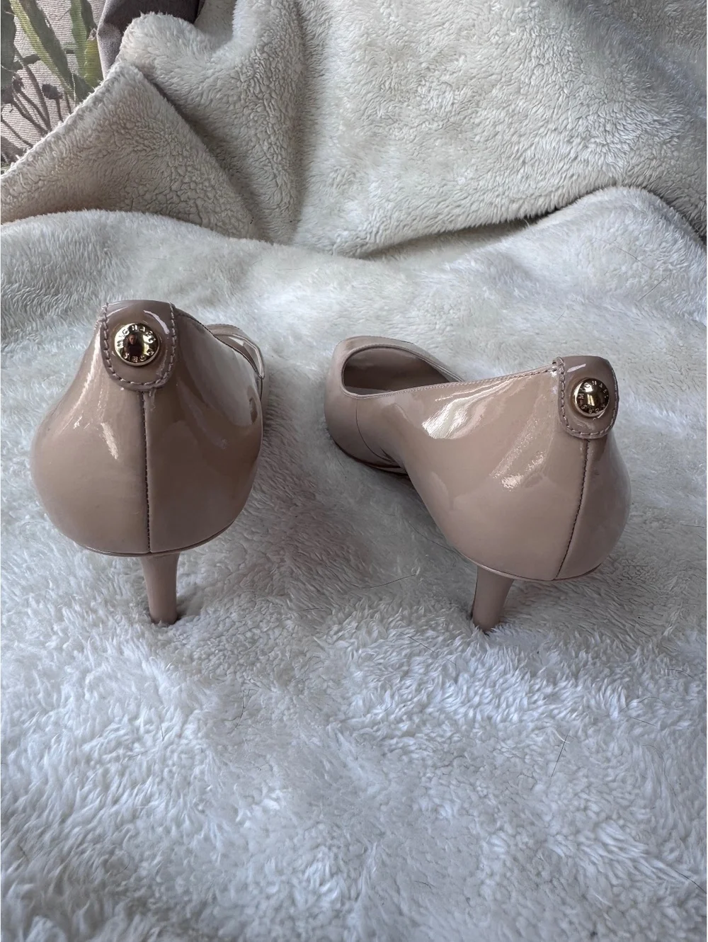 Michael Kors women’s patent leather peep-toe pumps in a classic nude/blush color